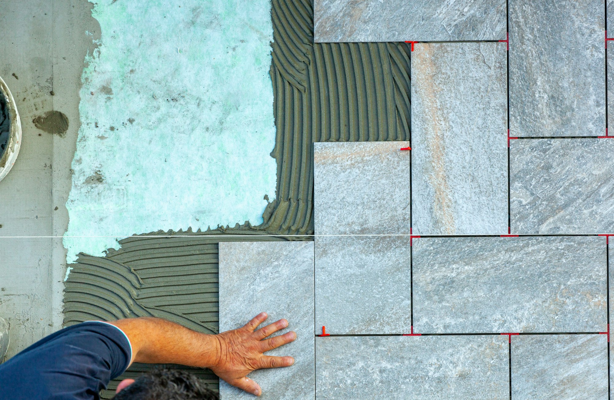 Top view of a tiler working in a garden.